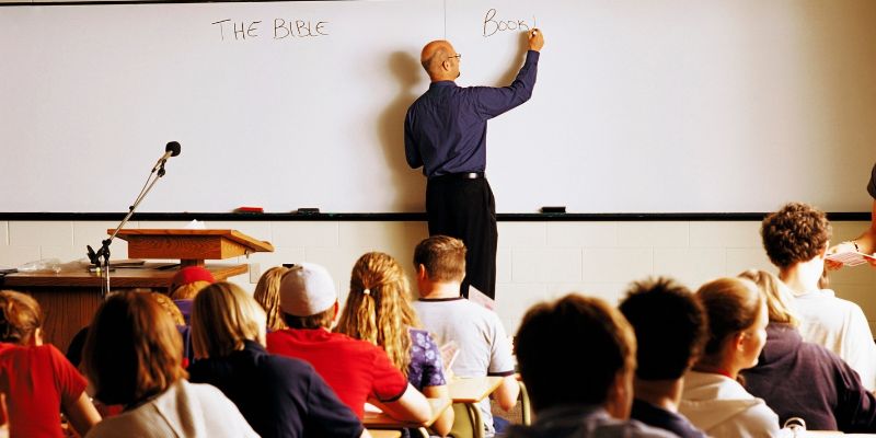 A teacher and students engaged in an interactive ethics or Catholic lesson